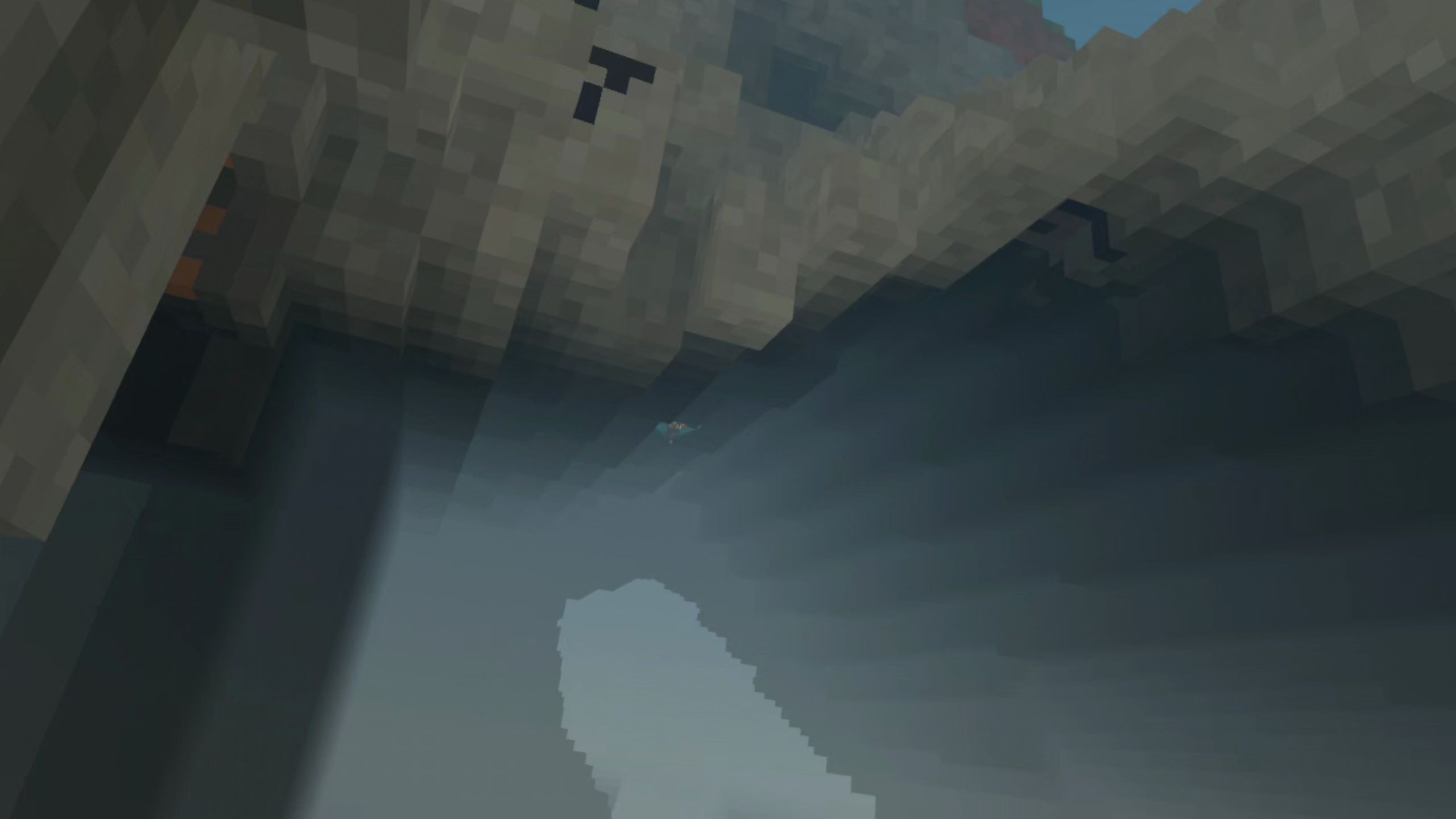 Light falling through a cave opening onto misty rock