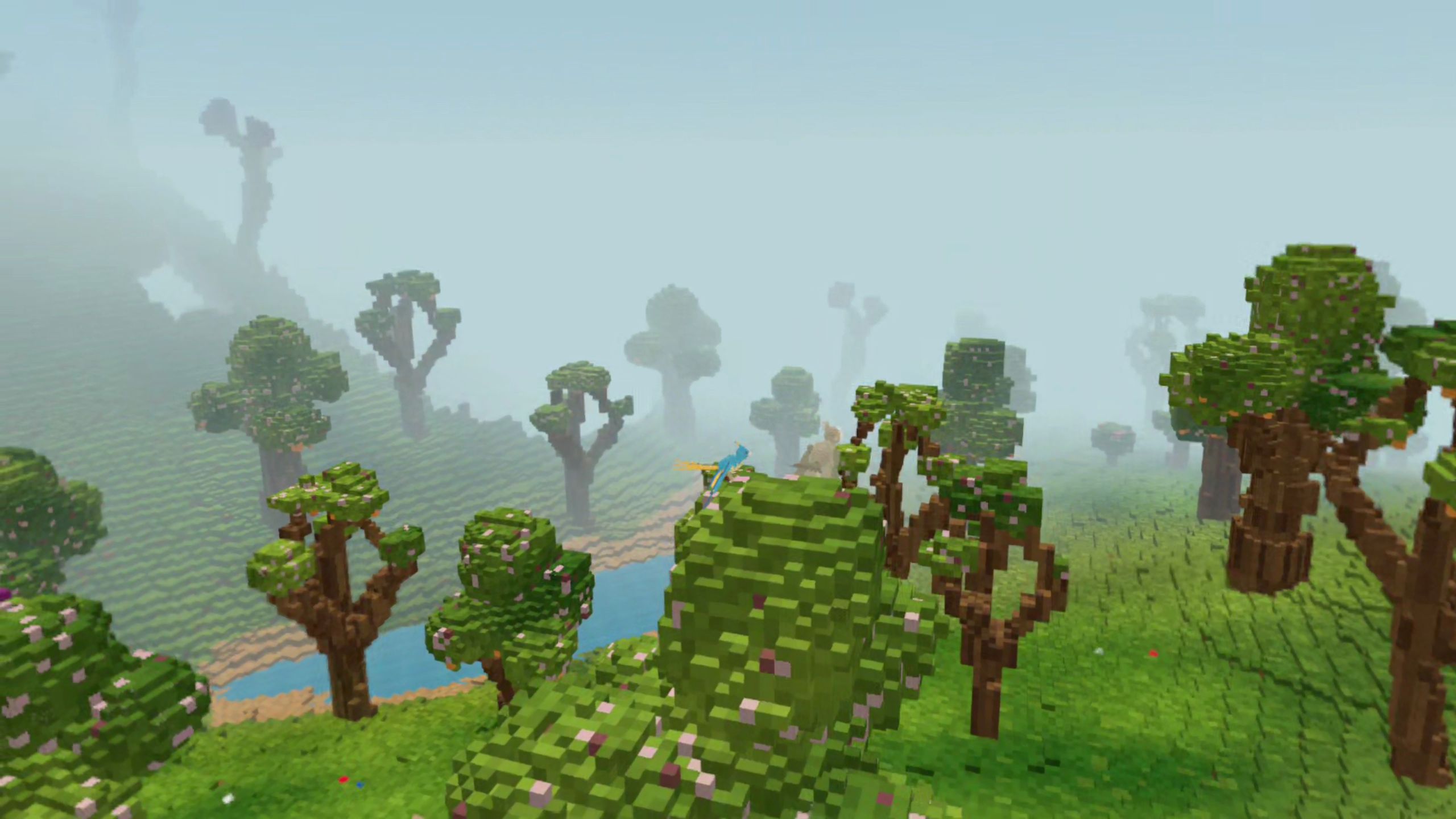 Misty voxel woodland with a river winding between curled trees